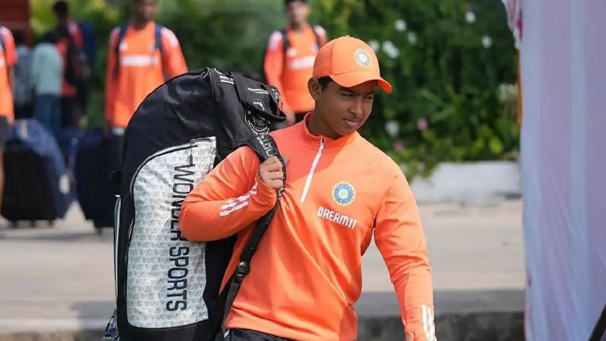 Vaibhav Suryavanshi, young Indian cricketer, carrying sports gear in official team training kit.