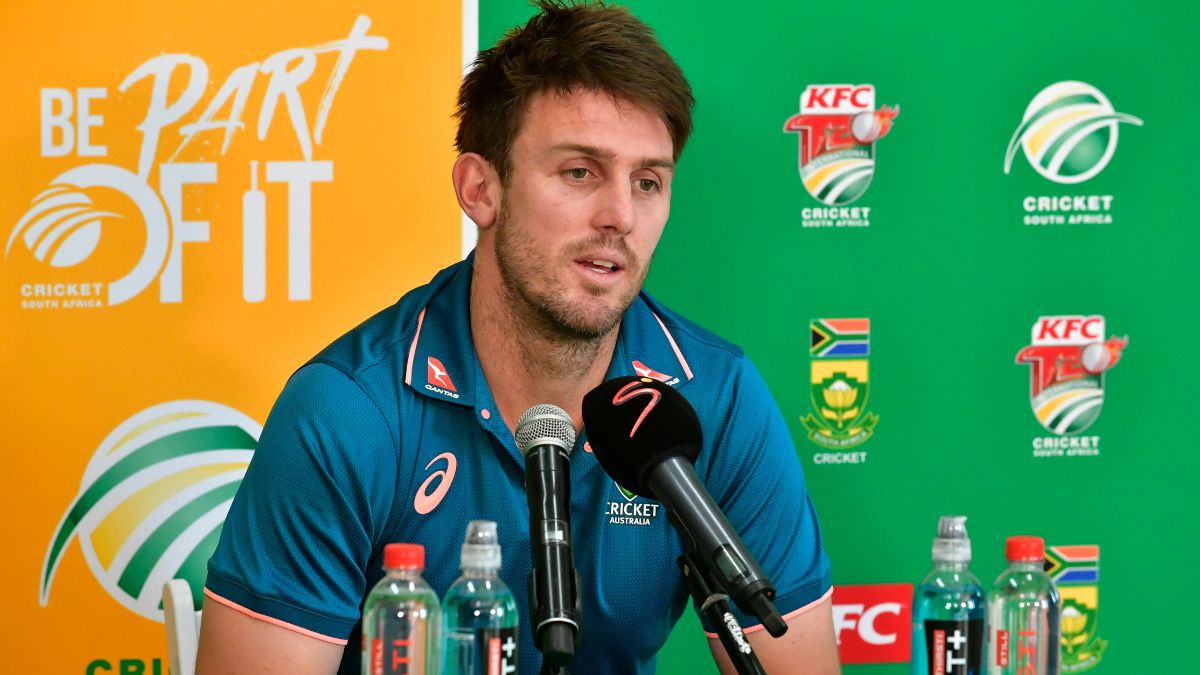 Mitchell Marsh explains cricket injury ruling him out of 2025 Champions Trophy and IPL, holding crutches during press conference.