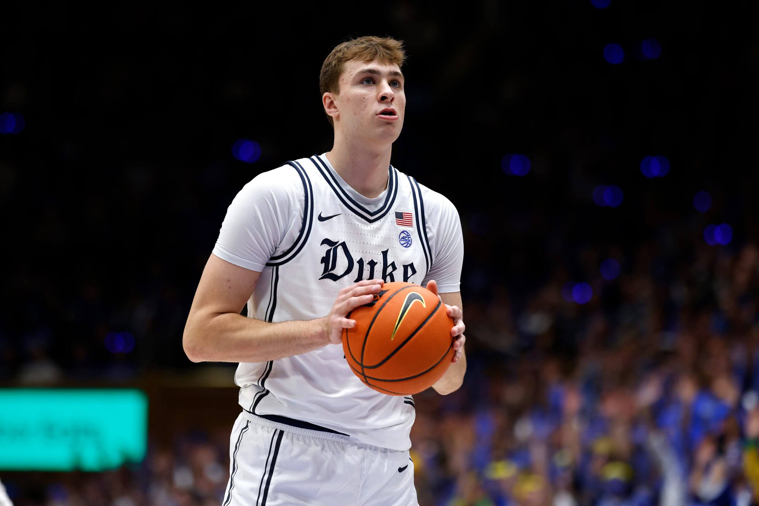 Cooper Flagg holding Nike basketball in Duke University basketball dress.
