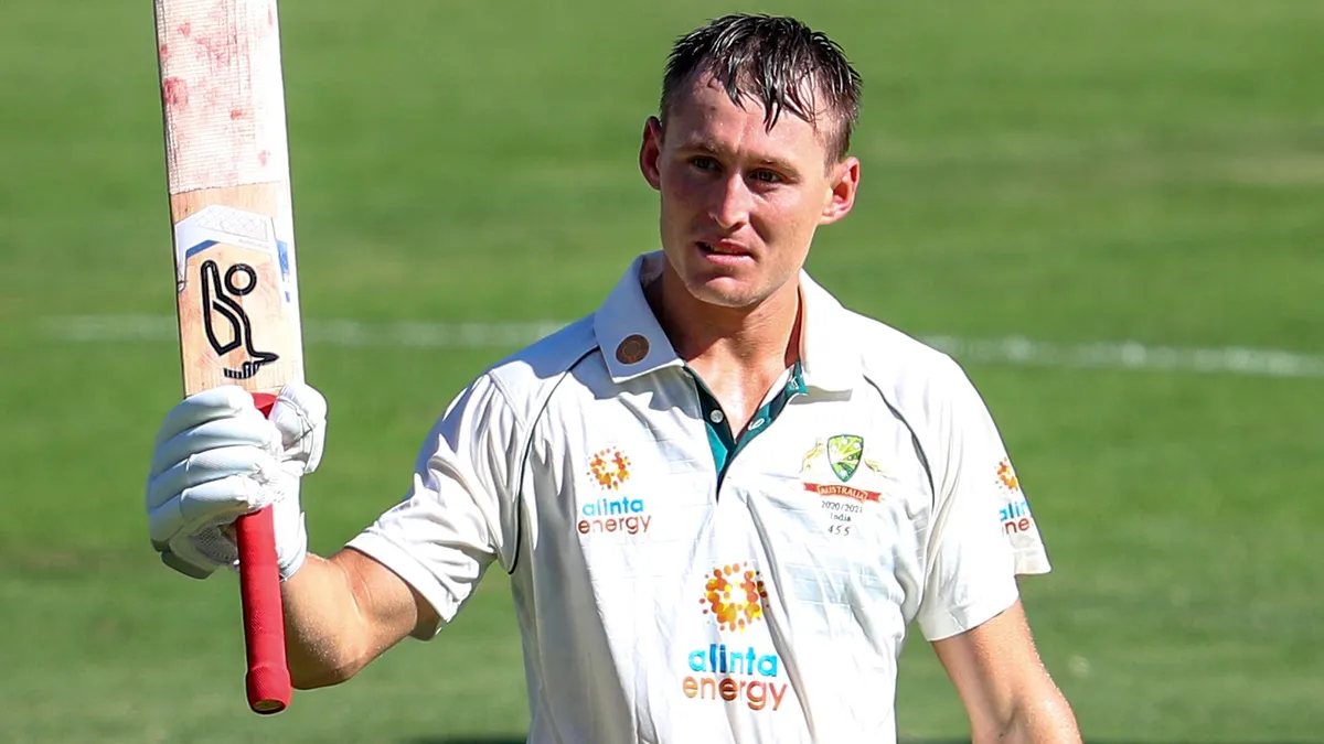 Marnus Labuschagne raises bat after scoring runs in a Test match for Australia